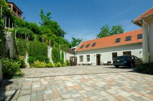 a driveway in front of a building with a car at Monbuhim Twin in Veszprém
