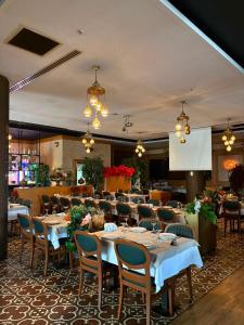 a dining room with tables and chairs and a screen at PERLA SUİTES hotel in Istanbul
