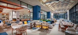 a restaurant with tables and chairs in a building at Trendy Perge Resort & Suites in Aksu