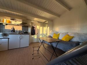 a living room with a couch and a table at Rävboet in Österbi