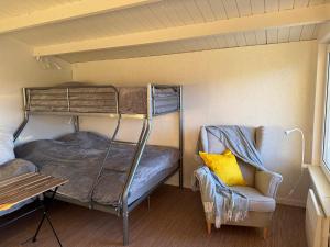 a room with two bunk beds and a couch at Rävboet in Österbi