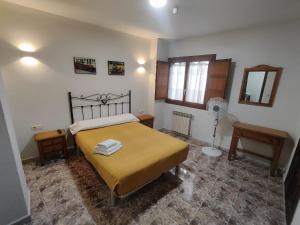 a bedroom with a bed and a fan at Hostal La Alberca in La Alberca +20 photos
