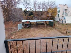 a view of a picnic shelter from a balcony at Complejo Los Arrayanes - Plottier in Plottier