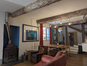 a living room with a table and a fireplace at The Artist's House in Céret