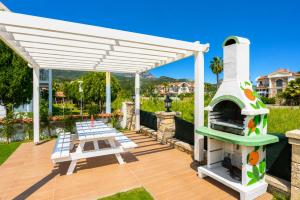 a pergola with a pizza oven on a patio at Villa Portakal Blossom in Dalyan