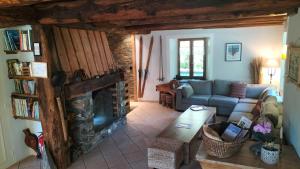 a living room with a couch and a fireplace at LA JARBELLE - Gîte et Spa in Les Orres