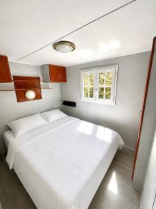 a bedroom with a white bed and a window at La Dune d’Erdeven in Erdeven +14 photos
