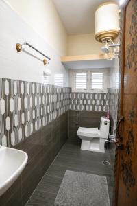 a bathroom with a toilet and a sink at Ferro Livingz in Kumbalgod +46 photos