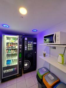 a room with a vending machine and a microwave at Alcorso Pension in Banská Bystrica