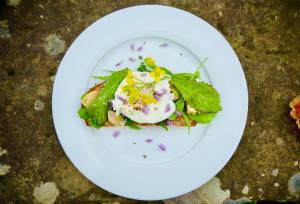 a white plate with a salad on a table at Wester Auchraw Croft B&B in Lochearnhead