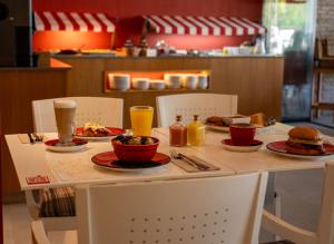 a table with plates of food and drinks on it at The Red Hotel - Adults Only in San Antonio +50 photos