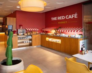 a restaurant with a red cafe sign on the wall at The Red Hotel - Adults Only in San Antonio
