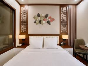 a bedroom with a large white bed and a desk at NEW SUN NAM ĐỊNH hotel in Nam Ðịnh +38 photos