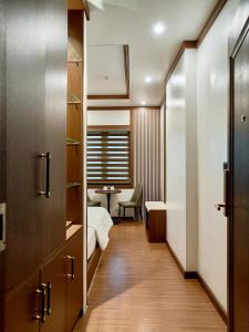 a corridor of a room with a bed and a table at NEW SUN NAM ĐỊNH hotel in Nam Ðịnh