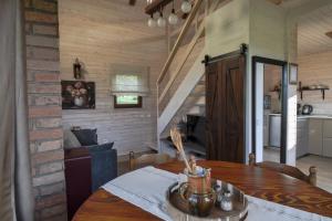 a kitchen and dining room with a wooden table at Golubek Holiday House in Banščica