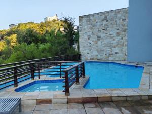 a swimming pool on top of a brick building at Stay at the Herold 605 in Herolds Bay