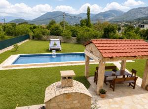 a backyard with a pool with a table and a gazebo at La Hacienda Percobic-Serenity & private pool in Bar