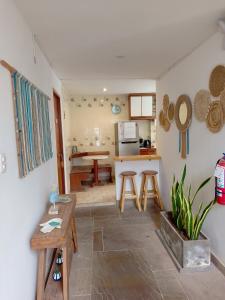 a living room with a table and a kitchen at VIVEMAR PUNTA HERMOSA - Beach House Lima - Perú in Punta Hermosa