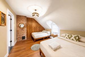 a bedroom with two beds and a brick wall at Pool House Near NYC FIFA Stay for Groups in Roselle +73 photos