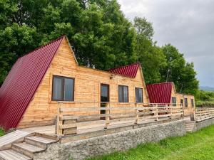 a wooden cabin with a red roof at Shahunts Resort in Odzun