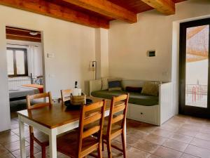 a living room with a table and a couch at Casale Milleluci - Country House in Senigallia