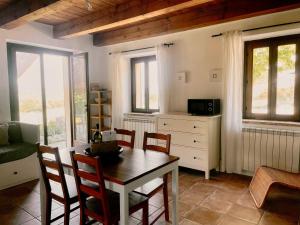 a living room with a dining room table and chairs at Casale Milleluci - Country House in Senigallia