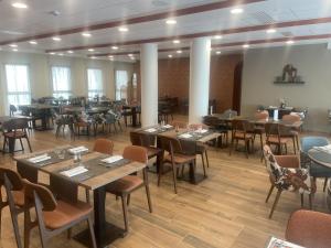 a restaurant with tables and chairs in a room at DOMITYS - Villa Molinis in Moulins