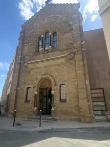 a large brick building with a large doorway at DOMITYS - Villa Molinis in Moulins