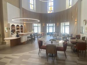 a restaurant with tables and chairs and a bar at DOMITYS - Villa Molinis in Moulins