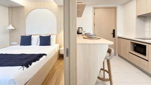a hotel room with a bed and a kitchen at Peaceful Fantasia Condo Kamala in Surin Beach