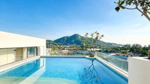 a swimming pool on the roof of a building at Peaceful Fantasia Condo Kamala in Surin Beach