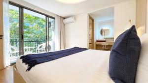 a bedroom with a white bed and a large window at Peaceful Fantasia Condo Kamala in Surin Beach +69 photos