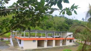 a building in the middle of a forest at Hostal El Bosque in Pedernales