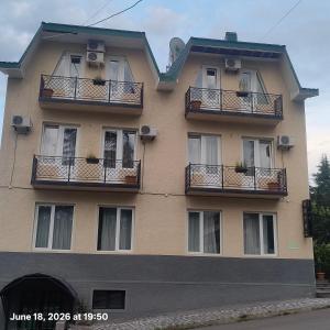 a tall building with balconies and windows on it at Telavi ERMA in Telavi