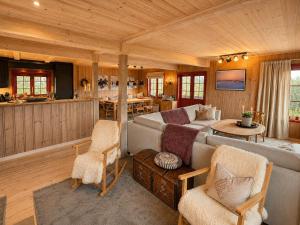 a living room with a couch and a table at Spacious cabin with beautiful Geilo views in Geilo