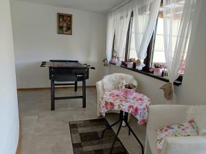 a room with a desk and a table and a chair at Vila Veles in Dolný Kubín