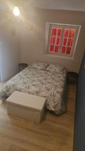 a bedroom with a bed and a window at Maison du golf in Nassigny