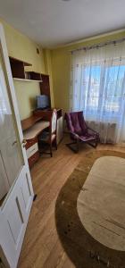 a room with a door and a desk and a chair at Casa Belu in Eforie Nord