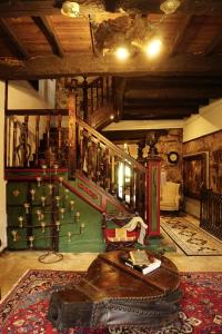 a living room with a table and a stair case at Casa de San Pedro de Cerceda in Villasante