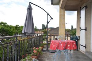 a table and an umbrella on a balcony at Pause Périgord in Saint-Cyprien +4 photos