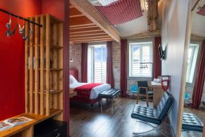 a room with a bedroom with a bed and a desk at Hotel Aux Terrasses in Tournus +105 photos
