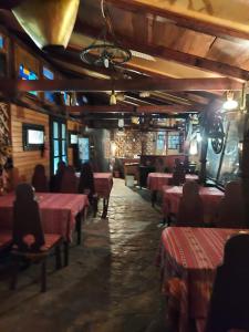 a restaurant with red tables and chairs and a bike on the ceiling at Casa Belu in Eforie Nord