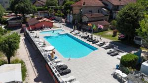 an overhead view of a swimming pool with chairs and umbrellas at Campeggio Tranquilla in Baveno