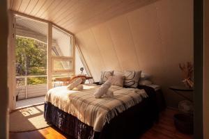 a bedroom with a bed and a large window at Stay North - Merimaa in Tallbacka