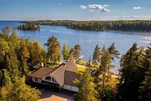 an aerial view of a house on the shore of a lake at Stay North - Merimaa in Tallbacka