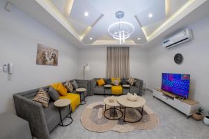 a living room with a couch and a tv at The view apartment 2 in Al Baha