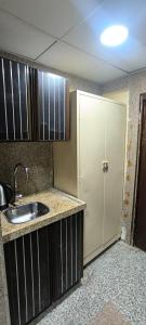 a kitchen with a sink and a white door at Zad Al Hayat in Mecca +46 photos