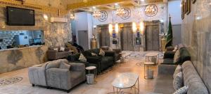 a living room with couches and chairs and a tv at Zad Al Hayat in Mecca