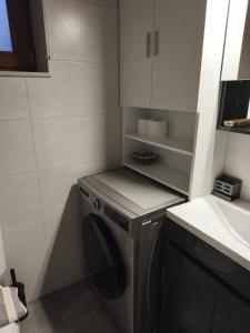 a kitchen with a washing machine and a sink at Tsitsinos Village Cottage in Zekros +63 photos