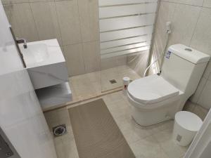 a small bathroom with a toilet and a sink at The view apartment 2 in Al Baha +25 photos